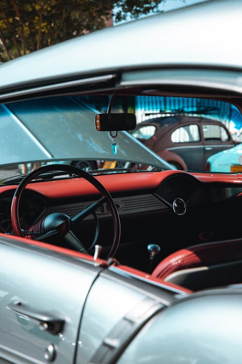 Red Dashboard and Black Steering Wheel of a Car