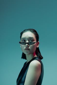 Portrait of an attractive Asian woman wearing trendy sunglasses, capturing a futuristic style and elegance.