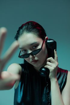 Woman in Black Sunglasses Holding Rotary Phone