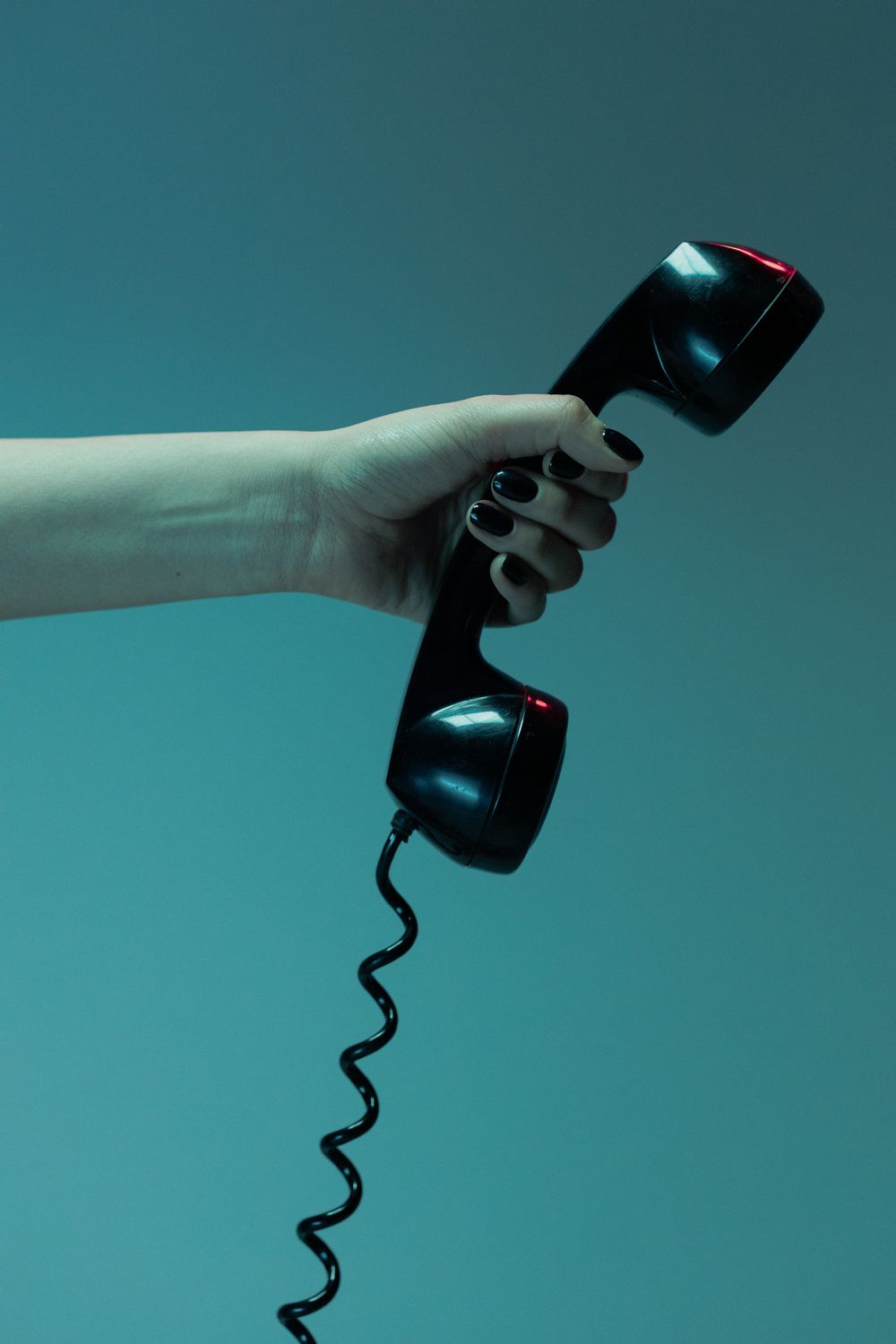 Phone Call Shot Close-Up Shot of Person Holding a Black Telephone · Free Stock Photo
