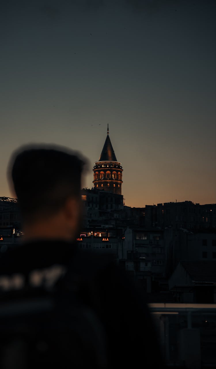 Back View Of A Man Looking At The Tower