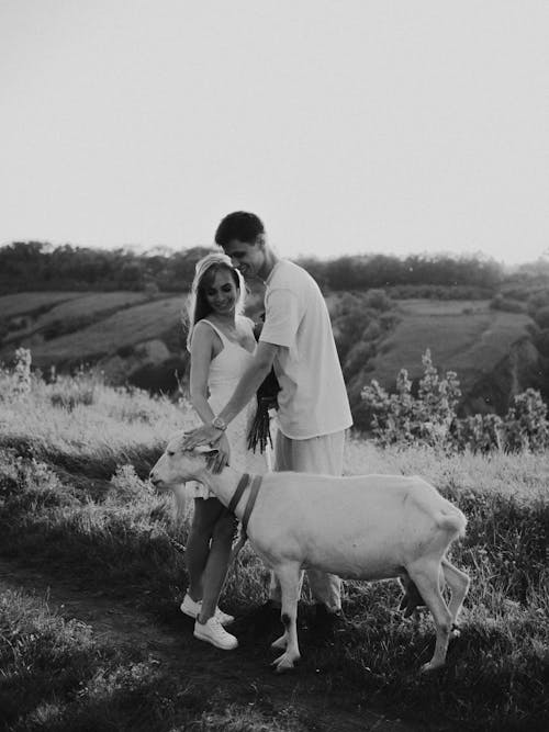 Man and Woman Holding a Goat