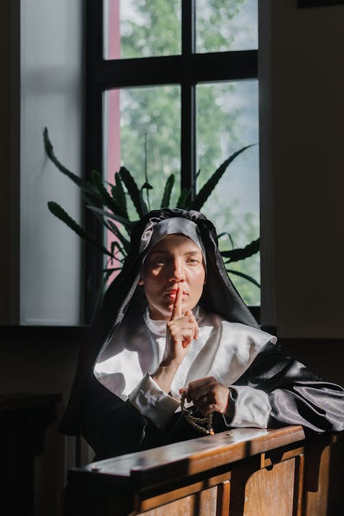 Free A Nun Doing Quiet Gesture in the Church Stock Photo