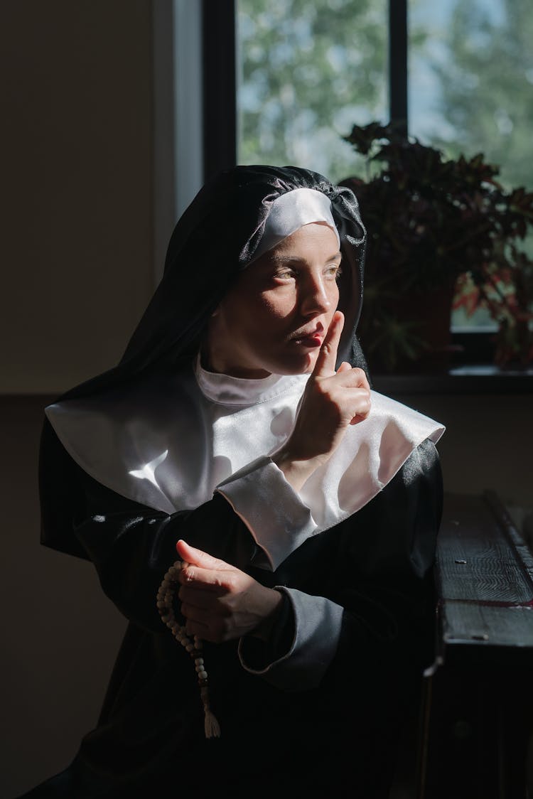 Sister Holding Rosary And Saying Shh