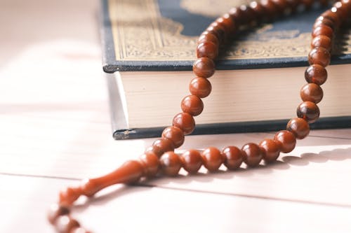 Close-up of a Rosary on Top of a Bible