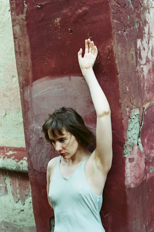 Woman Leaning on a Red Wall