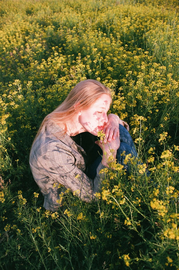 Woman Wearing Blazer Sitting On Flower Field