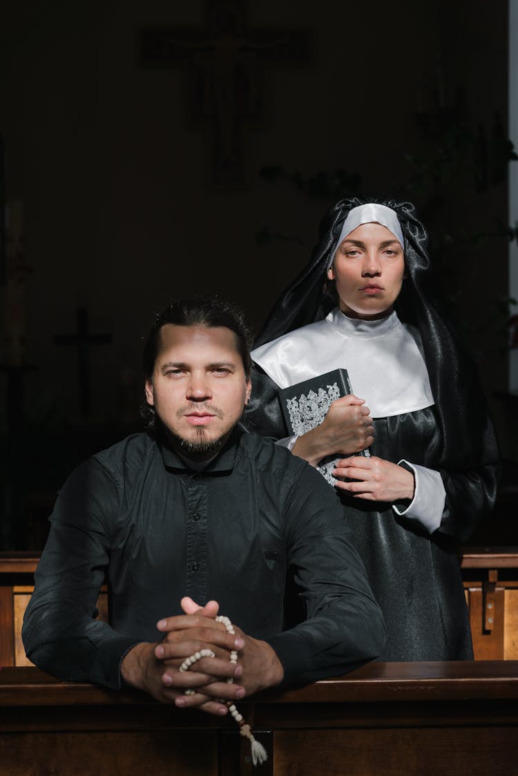 Priest And Nun Praying Together