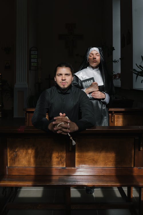 Photo of a Nun and Pastor Inside the Church