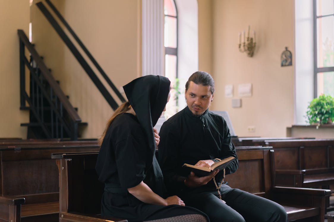 Man in Black Robe Playing Guitar