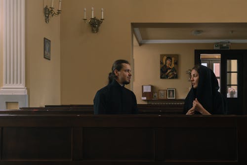 Priest Talking with Woman in Church