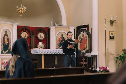 Free Man at Church's Altar Holding a Bible Stock Photo