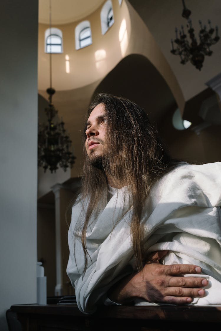 A Man Dressed In White Cloth Inside A Church