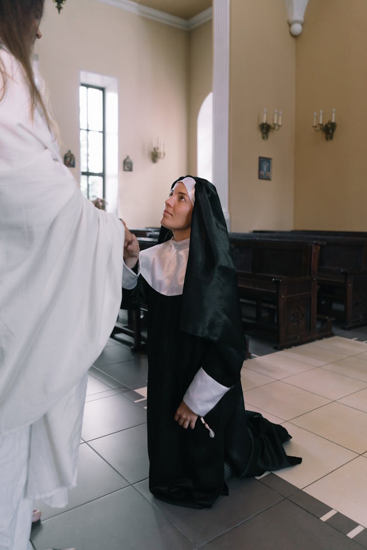 Nun Kneeling On The Floor 