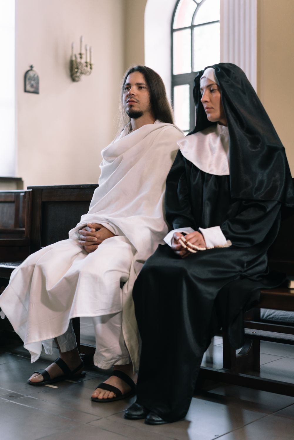 Sitting Robe Woman in Black Robe Sitting on Chair with a Man Wearing White Robe ...