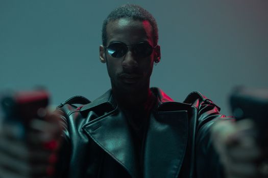 A cool and conceptual portrait featuring a black man in sunglasses and a leather jacket.