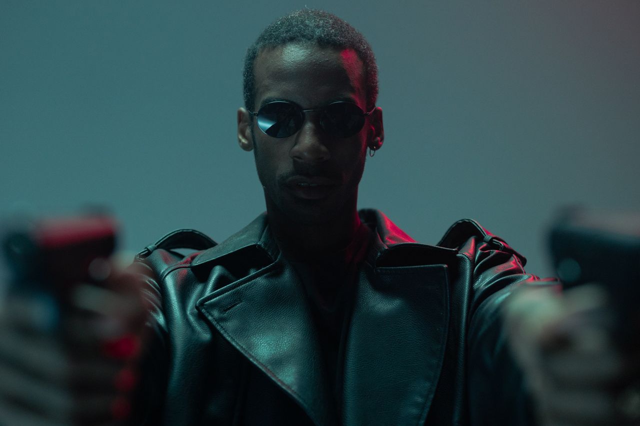 a cool and conceptual portrait featuring a black man in sunglasses and