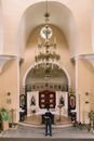 A Chandelier Over a Man Standing at the Altar