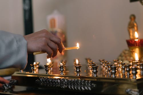 Free Person Holding a Lighted Candle Stick Stock Photo