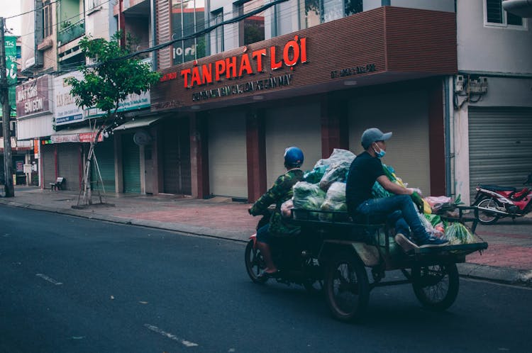 Men Riding A Tricycle