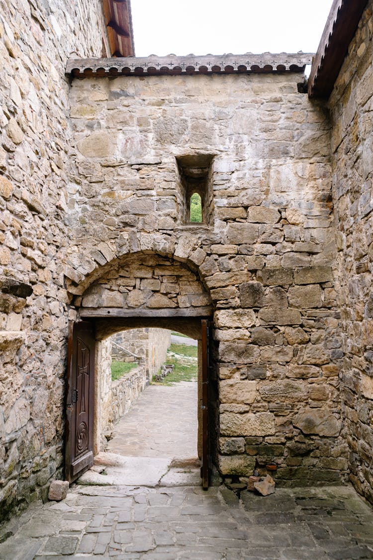 Ancient Stone Building Walls And Wooden Doors