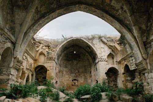 Free Explore the ancient stone arches and overgrown ruins of a historical abandoned structure. Stock Photo