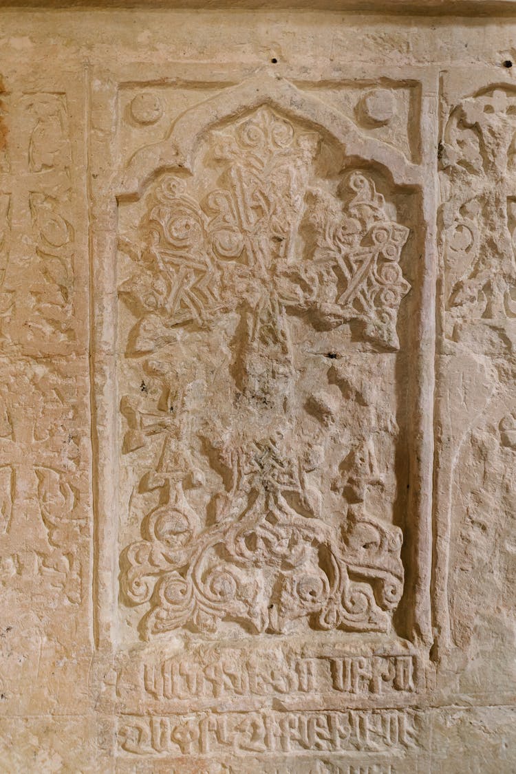 A Brown Concrete Wall With Carvings