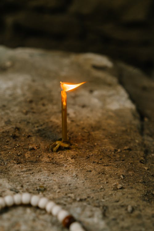Lighted Candle on the Rock