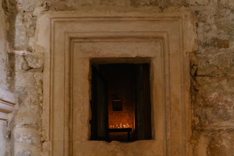 Altar With Lighted Candles Inside Medieval Stone Church