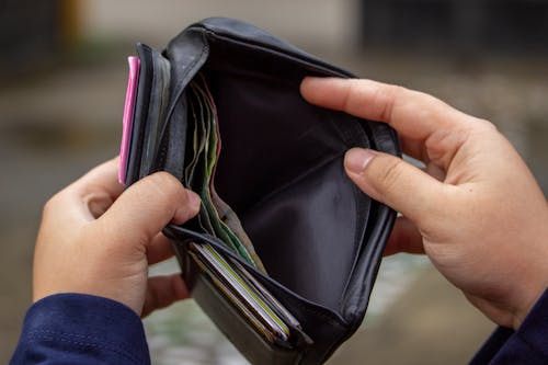 Free Person Holding a Black Wallet With Money Stock Photo