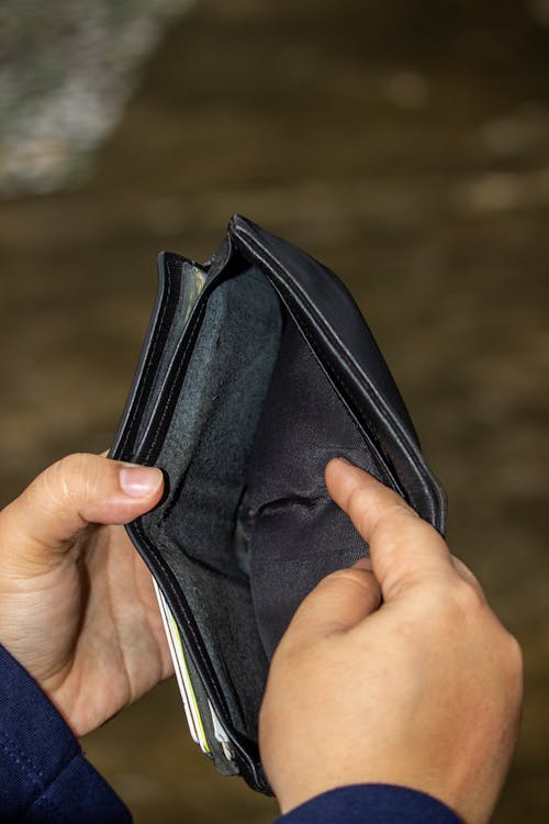 Free Person Holding a Black Wallet Stock Photo