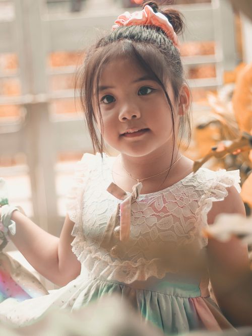 Free Charming young girl in a pastel dress enjoying a sunny day outdoors in Minglanilla, Philippines. Stock Photo