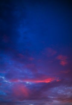 Capture of a vivid twilight sky with blue and purple clouds creating a dramatic atmosphere.
