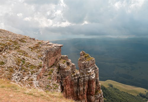 Brown Rocky Mountain Under White Clouds