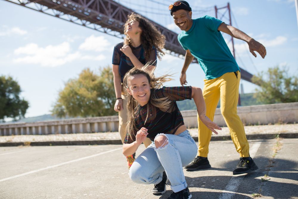 A crew of street dancers performing together in a city square