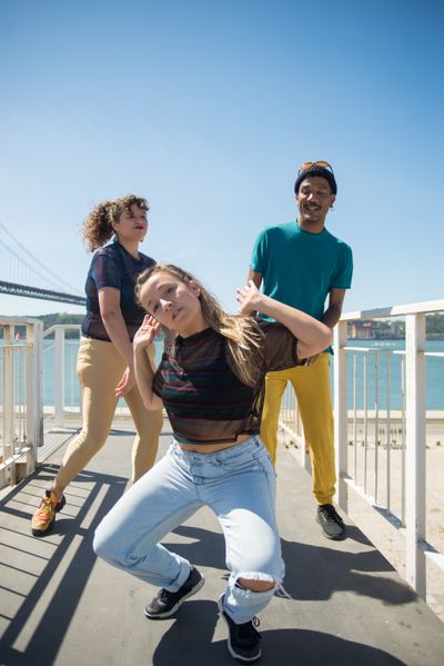 Three dancers by a sunny waterfront — Kampus Production on Pexels