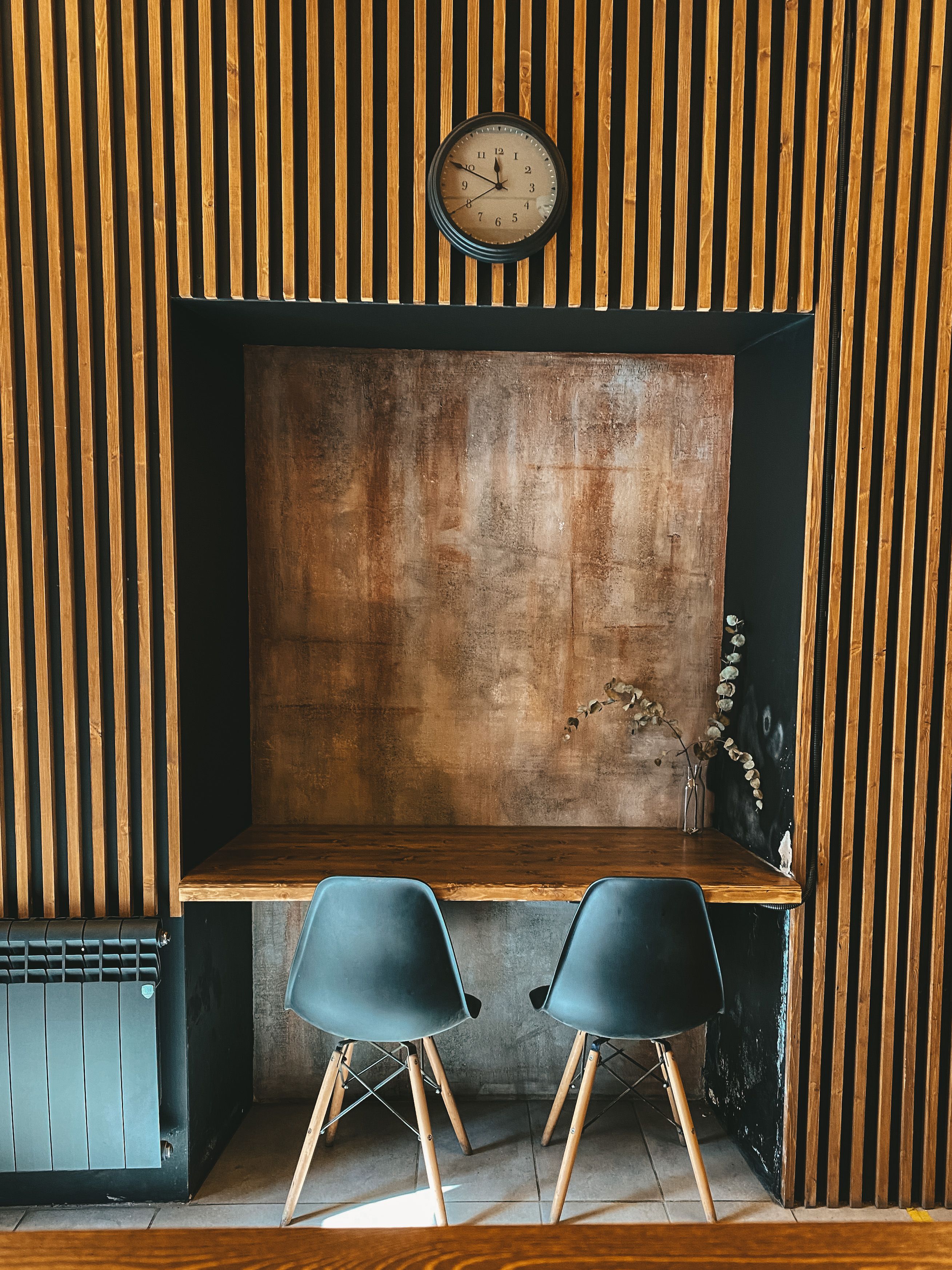 A large art panel above a dining table