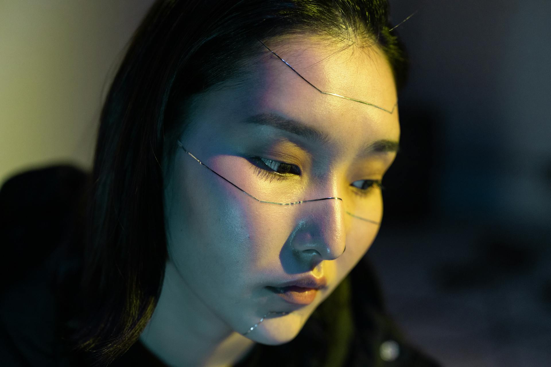 Close-up of an Asian woman in a cyberpunk-themed portrait with face stickers.