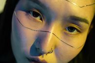 A Woman with Strips of Foil on Face and a Nose Ring