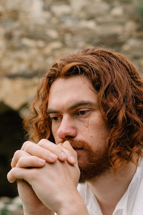 Free Bearded Man Praying with His Hands Clasped Stock Photo