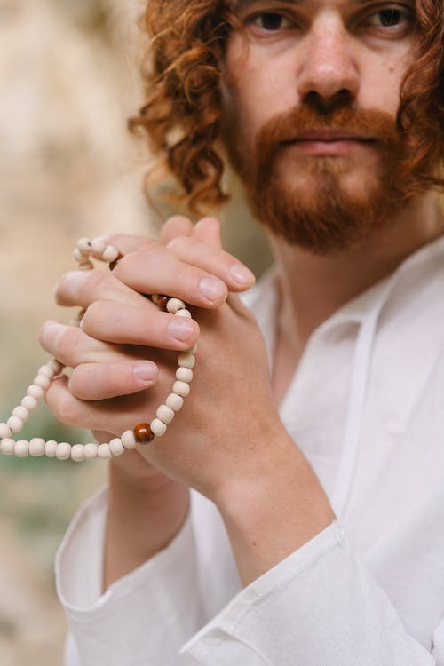Man Holding Prayer Beads