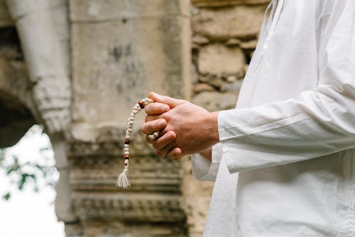 A Person Holding a Rosary
