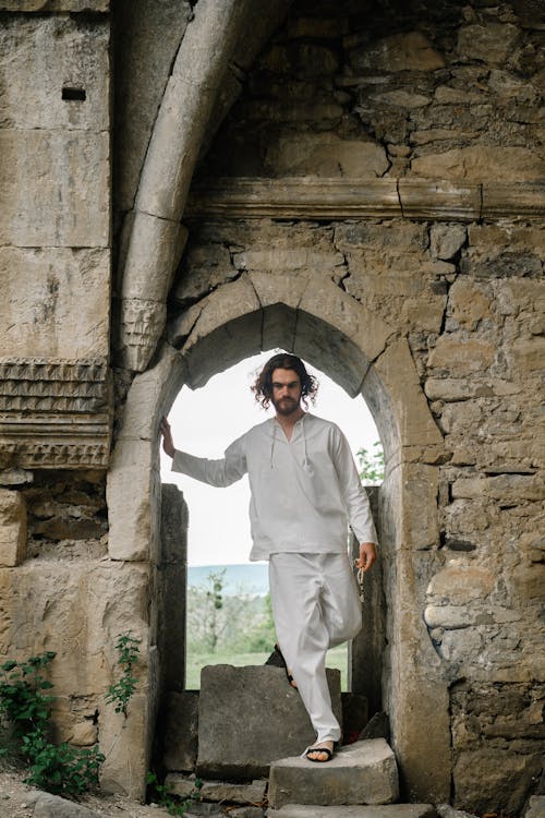 A Man on the Window of an Abandoned Building