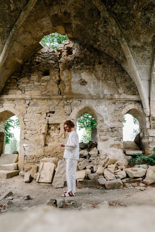 Man Standing in the Ruins of a Building 