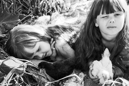 Little Girls Lying on the Ground with Chicks 