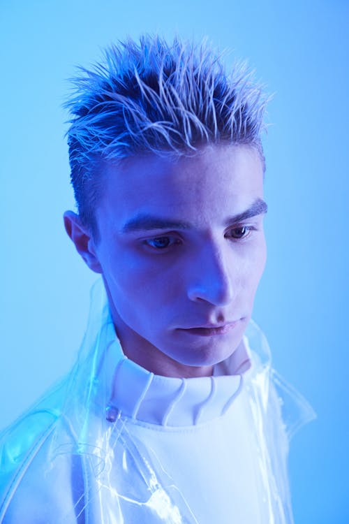 Man Wearing a Futuristic Outfit Posing in Studio in Blue Lighting 