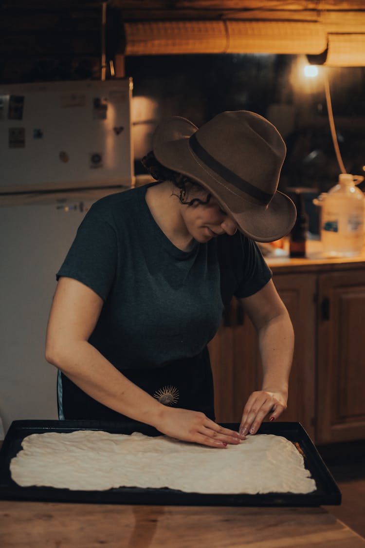 
A Woman Wearing A Hat While Baking