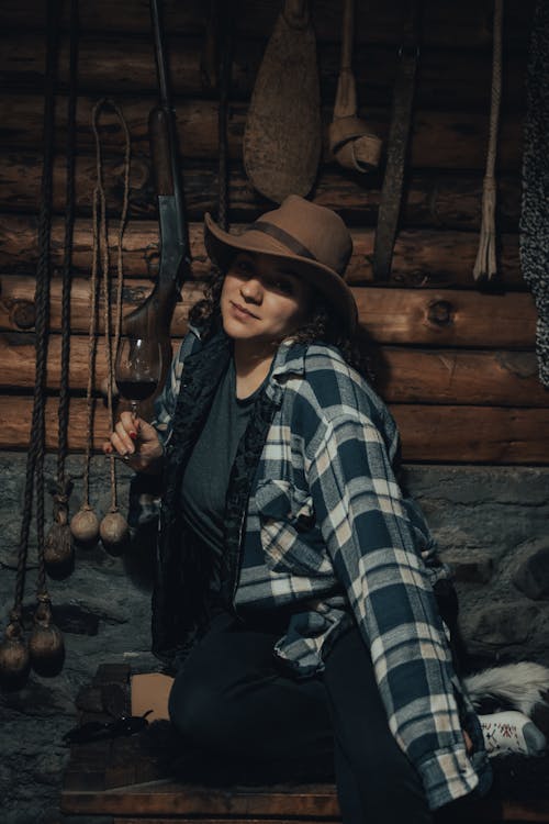 

A Woman in a Plaid Shirt and a Hat