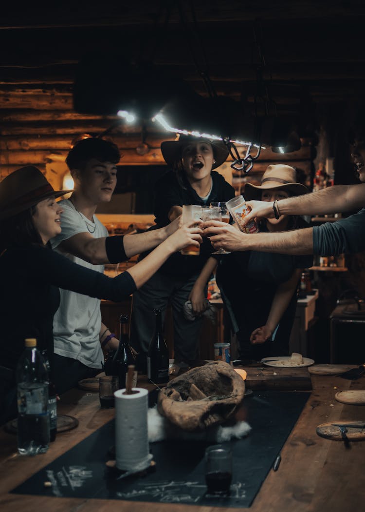 People Toasting Their Glasses Of Wine