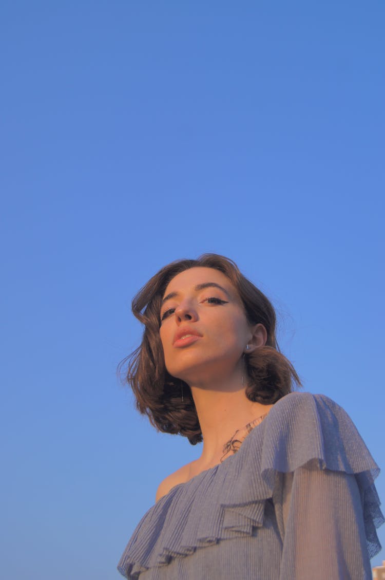 A Woman In Blue Ruffles Blouse